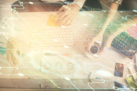 Double exposure of man and woman working together and data theme hologram drawing. Computer...