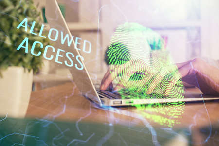 Double exposure of woman hands typing on computer and fingerprint drawing. Security concept.