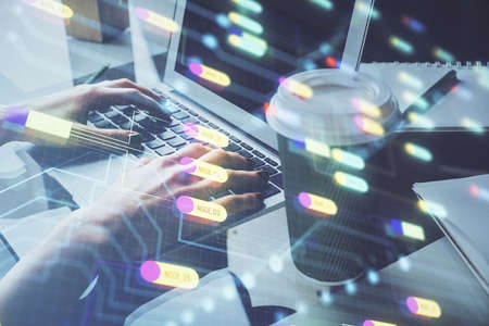 Double exposure of woman hands working on computer and data theme hologram drawing. Tech concept.