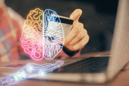 Double exposure of man hands typing on computer with credit card and brain theme drawing. E-commerce and AI concept.の写真素材