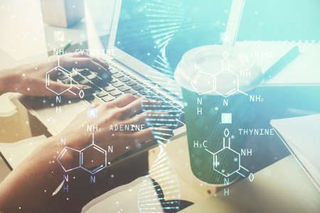 Double exposure of woman hands typing on computer and DNA hologram drawing. Medical education...