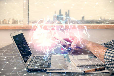 Double exposure of man's hand holding and using a digital device and brain hologram drawing. Data concept.の写真素材