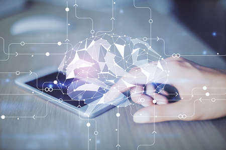 Double exposure of brain sketch hologram and woman holding and using a mobile device.