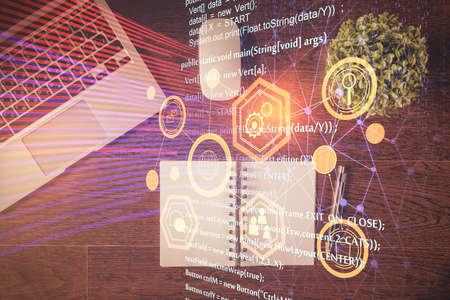 Double exposure of data theme drawing hologram over topview work table background with computer....