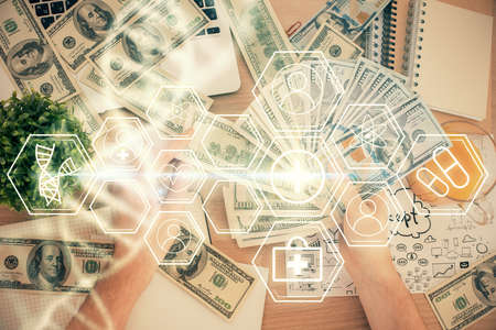 Multi exposure of dna drawing hologram and USA dollars bills and man hands. Medical education concept.の写真素材
