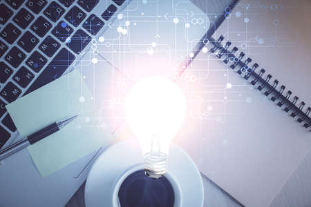 Bulb drawing over computer on the desktop background. Top view. Double exposure. Idea concept.の写真素材
