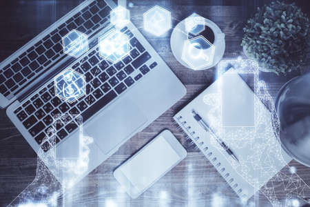 Technology hologram drawing over computer on the desktop background. Top view. Double exposure. Tech concept.の写真素材