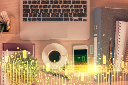 Double exposure of technology theme drawing over work table desktop. Top view. Global data analysis...