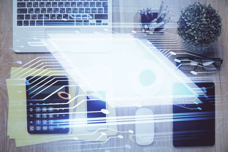 Double exposure of technology theme drawing over work table desktop. Top view. Global data analysis...