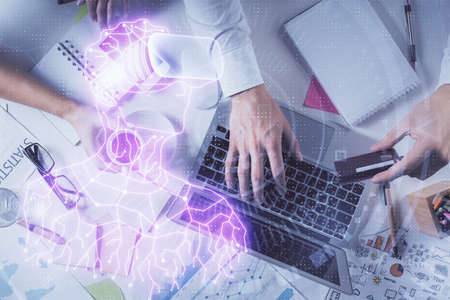 Double exposure of man's hands typing over computer keyboard and virtual reality hologram drawing....