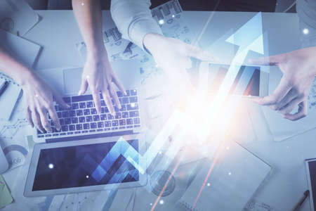 Double exposure of man and woman working together and arrows drawing. Computer background. Top View. Growth concept.の写真素材