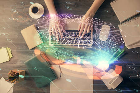 Double exposure of woman hands working on computer and data theme hologram drawing. Top View....