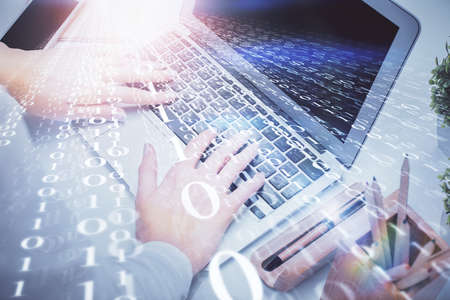 Double exposure of woman hands working on computer and data theme hologram drawing. Tech concept.