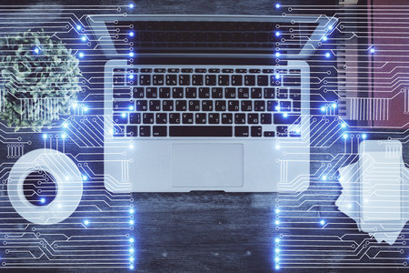 Technology hologram drawing over computer on the desktop background. Top view. Double exposure. Tech...