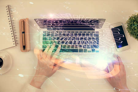 Double exposure of woman hands working on computer and data theme hologram drawing. Top View....