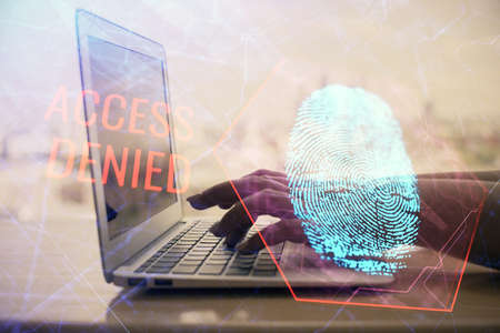 Double exposure of woman hands typing on computer and fingerprint drawing. Security concept.