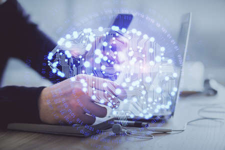 Double exposure of man's hand holding and using a digital device and brain hologram drawing. Data concept.の写真素材
