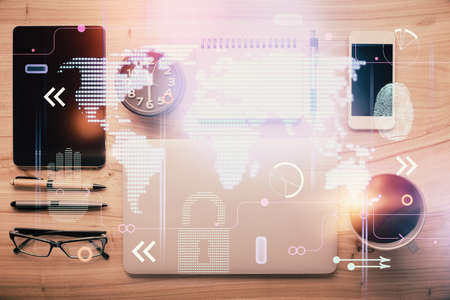 Double exposure of map hologram drawing over desktop. Top view. International connection concept.