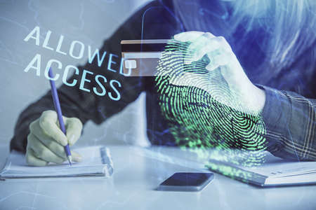 Multi exposure of woman on-line shopping holding a credit card and finger print drawing. Security...