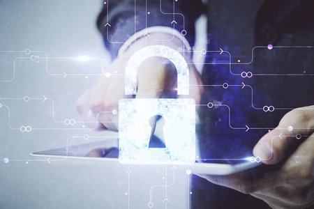 Multi exposure of man's hands holding and using a digital device and lock drawing. Security concept.の写真素材