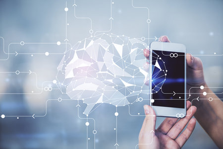 Double exposure of brain sketch hologram and woman holding and using a mobile device.