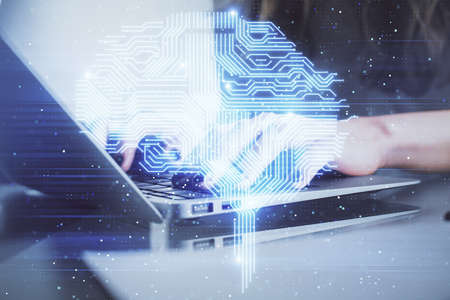 Double exposure of woman hands working on computer and brain hologram drawing. Ai concept.