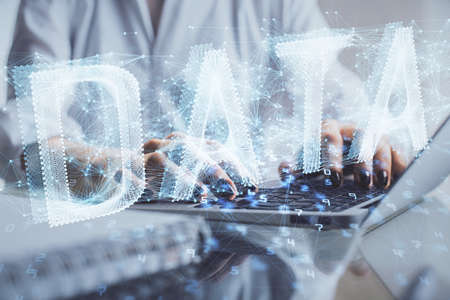 Double exposure of woman hands working on computer and data theme hologram drawing. Tech concept.