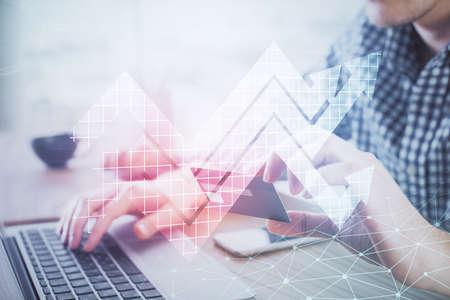 Double exposure of man hands holding a credit card and arrows drawing. Growth in E-commerce sales...