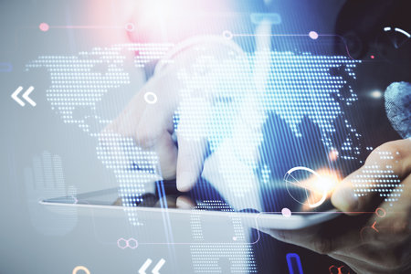 Multi exposure of man's hands holding and using a digital device and map drawing. International...