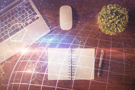 Double exposure of map hologram drawing over study table background with computer. Concept of...