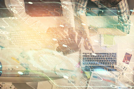 Double exposure of man and woman working together and data theme hologram drawing. Computer...