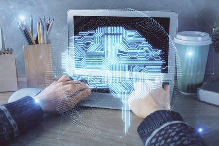 Double exposure of woman hands working on computer and brain hologram drawing. Ai concept.