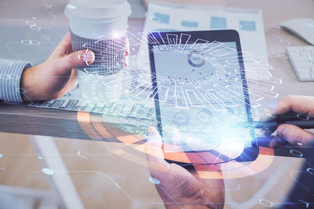 Multi exposure of man's hands holding and using a digital device and data theme drawing. Innovation concept.の写真素材