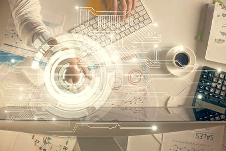 Double exposure of man's hands typing over computer keyboard and data theme hologram drawing. Top...