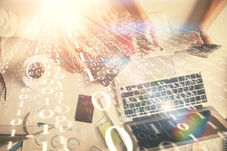 Double exposure of man and woman working together and data theme hologram drawing. Computer background. Top View.の写真素材