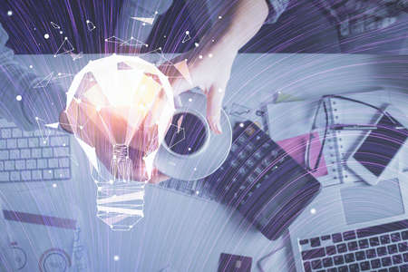Double exposure of man and woman working together and bulb drawing. Computer background. Top View. Idea concept.の写真素材