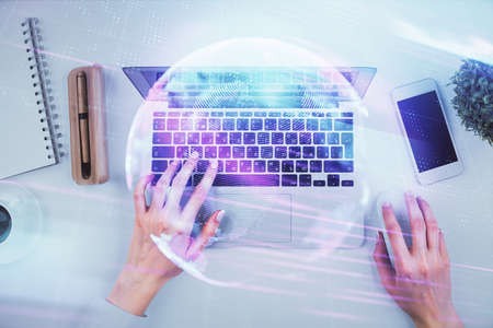 Double exposure of woman hands working on computer and tech theme hologram drawing. Top View. Technology concept.の写真素材