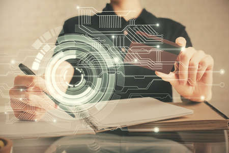 Double exposure of man hands holding a credit card and data theme drawing. E-commerce and technology concept.の写真素材