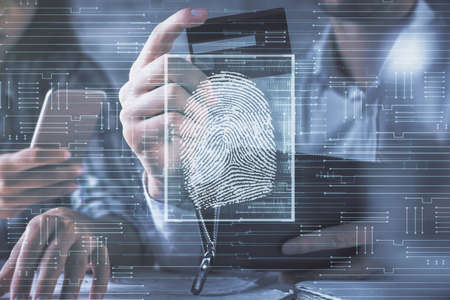 Double exposure of man and woman on-line shopping holding a credit card and fingerprint hologram...