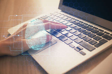 Double exposure of woman hands typing on computer and fingerprint drawing. Security concept.