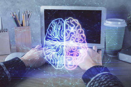 Double exposure of woman hands working on computer and brain hologram drawing. Ai concept.の写真素材