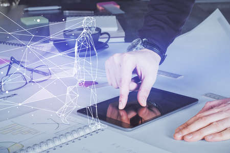 Double exposure of man's hands holding and using a mobile device and creative hologram drawing.の写真素材