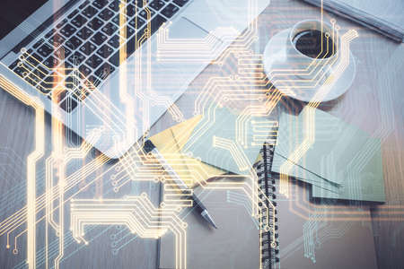 Technology hologram drawing over computer on the desktop background. Top view. Double exposure. Tech...