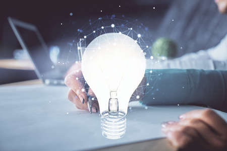 Double exposure of bulb drawing over people taking notes background. Concept of ideaの写真素材