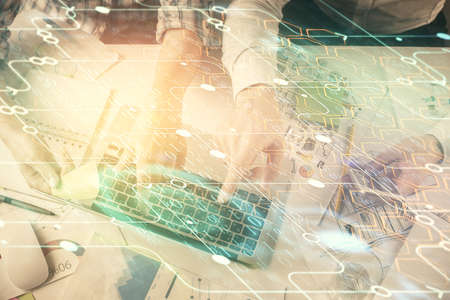 Double exposure of man and woman working together and data theme hologram drawing. Computer...