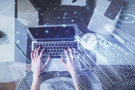 Double exposure of woman hands working on computer and buildings construction hologram drawing. Top View. smart city concept.の写真素材