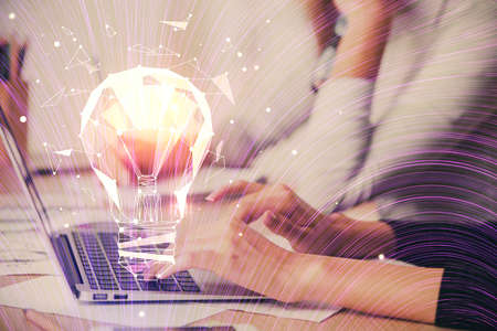 Double exposure of woman hands typing on computer and light bulb drawing. Idea concept.
