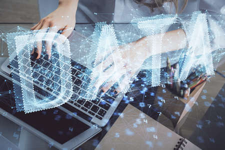 Double exposure of woman hands working on computer and data theme hologram drawing. Tech concept.
