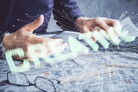 Double exposure of man's hands holding and using a mobile device and creative hologram drawing.の写真素材