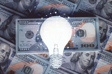 Double exposure of light bulb drawing over usa dollars bill background. Concept of idea.の写真素材